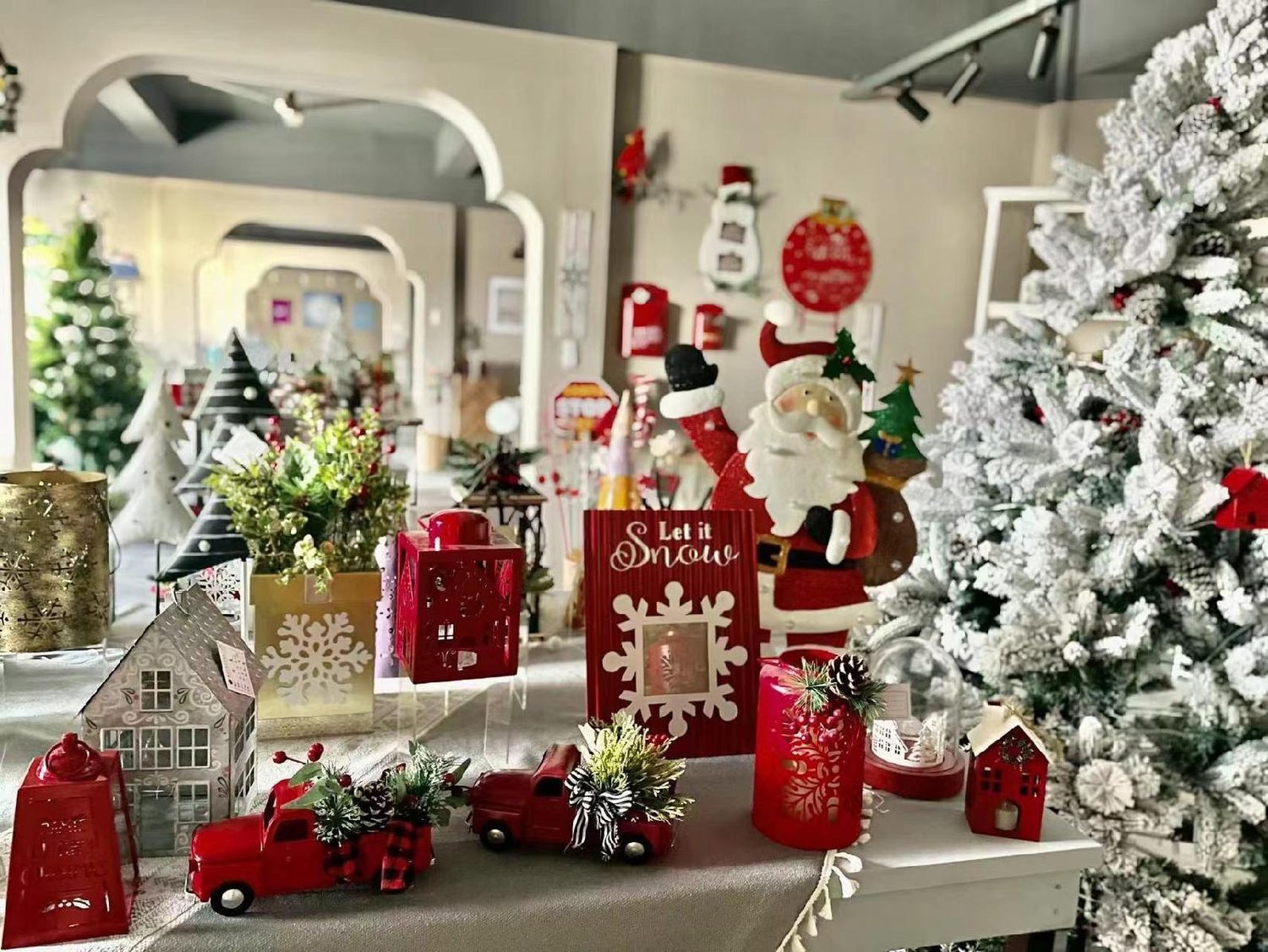 A Christmas set with a flocked tree, red truck pieces, houses and Santa figures