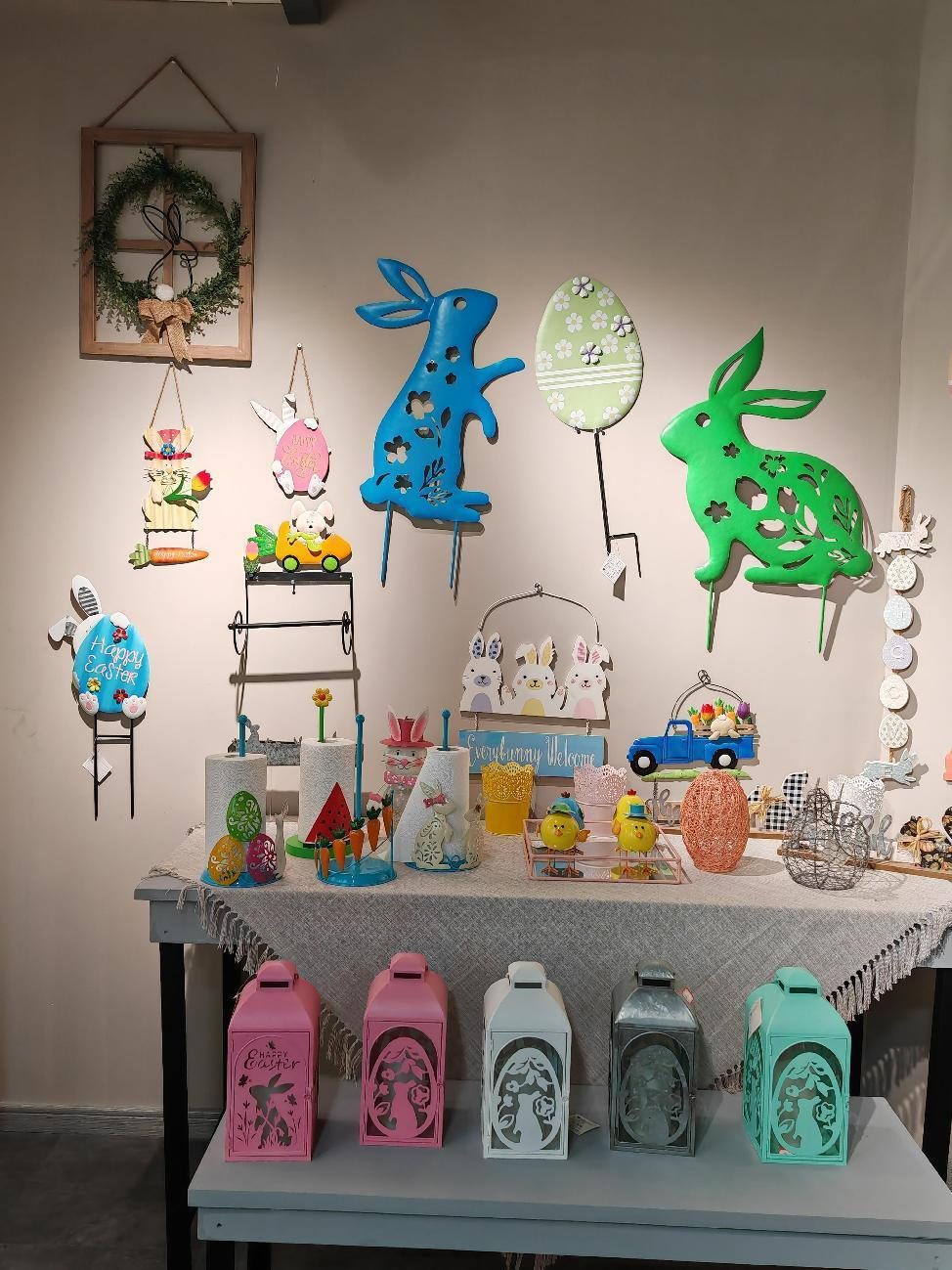 An Easter and spring display: pastel bunnies, eggs and painted lanterns on a tiered stand