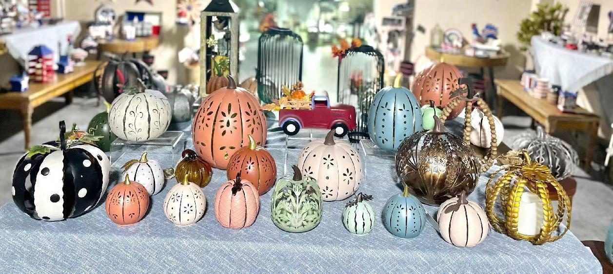 A long table of painted pumpkins in matte and metallic finishes